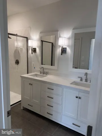 a metallic refrigerator freezer sitting in a kitchen