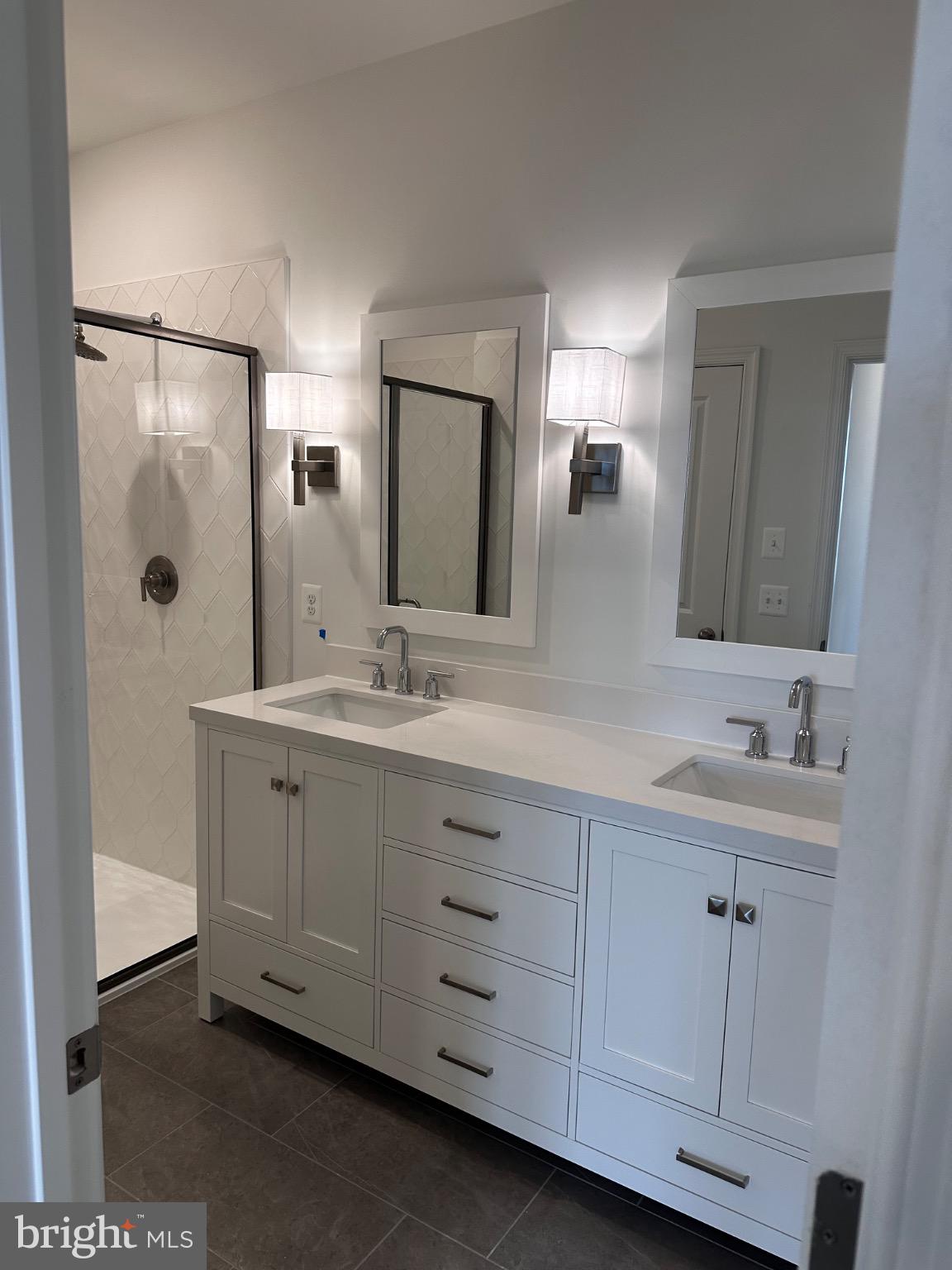 2504 West Peninsula Drive, Unit A Baltimore, MD 21207 - Photo 17 of 33 a bathroom with a double vanity sink and mirror