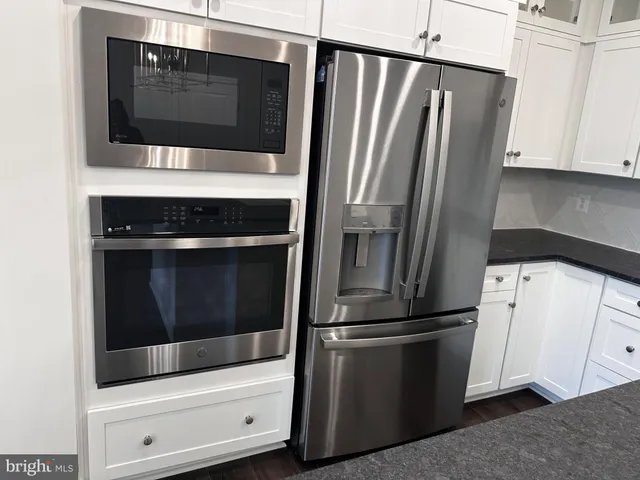a kitchen with granite countertop a stove and a sink
