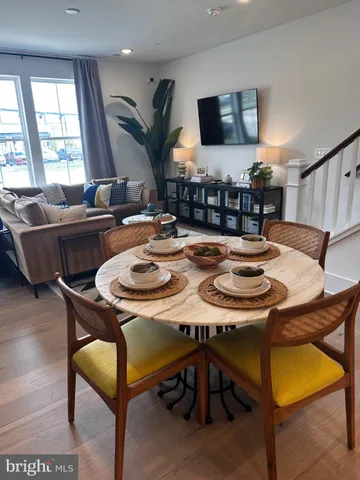 a dining room with furniture and wooden floor