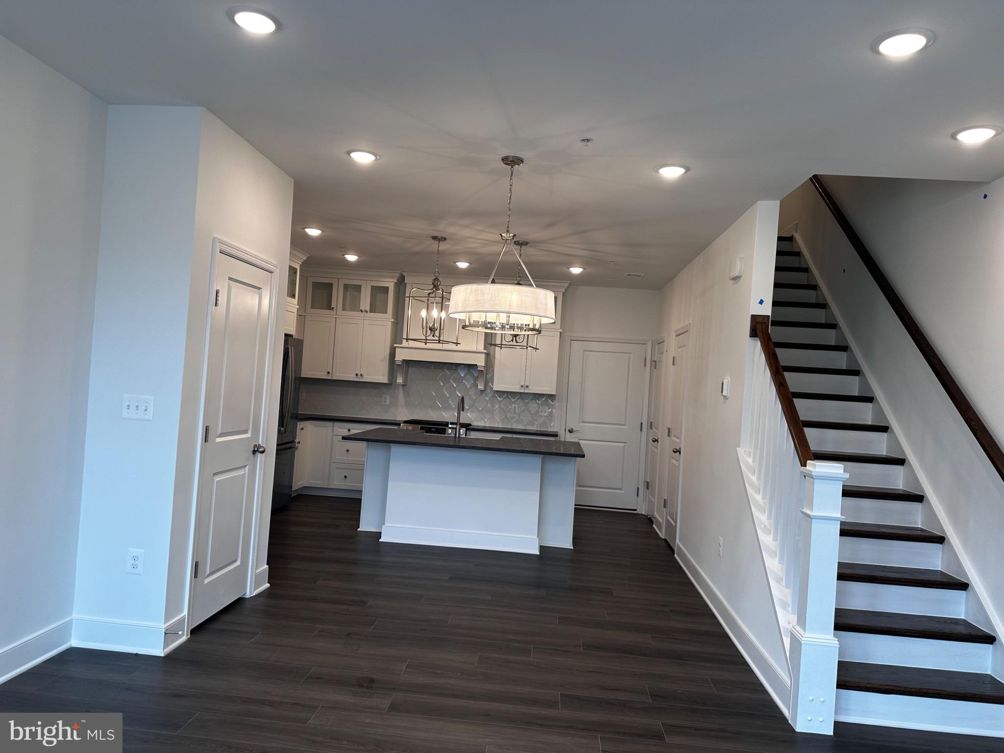 2504 West Peninsula Drive, Unit A Baltimore, MD 21207 - Photo 21 of 33 a kitchen with stainless steel appliances a refrigerator and a wooden floor