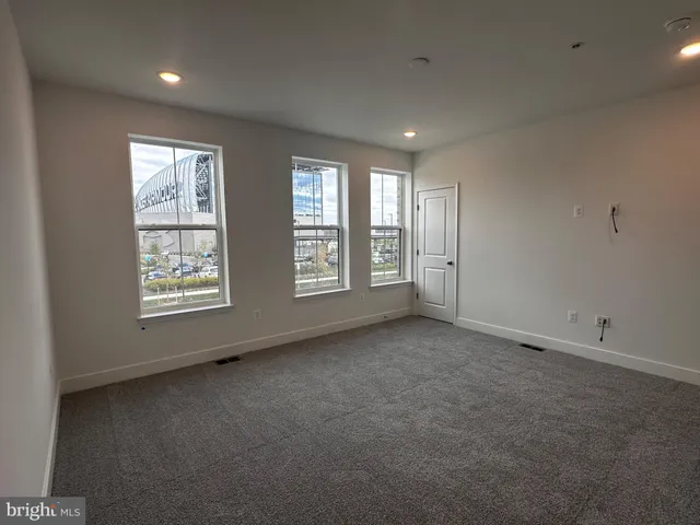 a bathroom with a toilet and a window