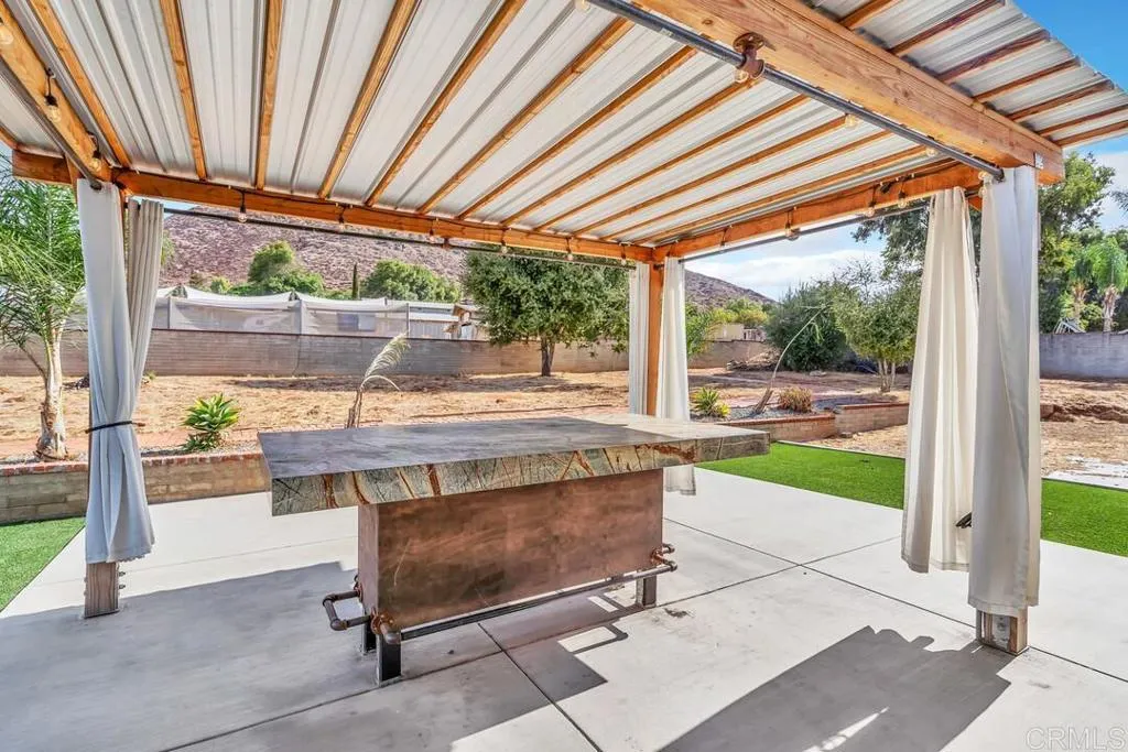 988 Pepper Drive El Cajon, CA 92021 - Photo 12 of 41 a view of porch with a table and chairs under an umbrella