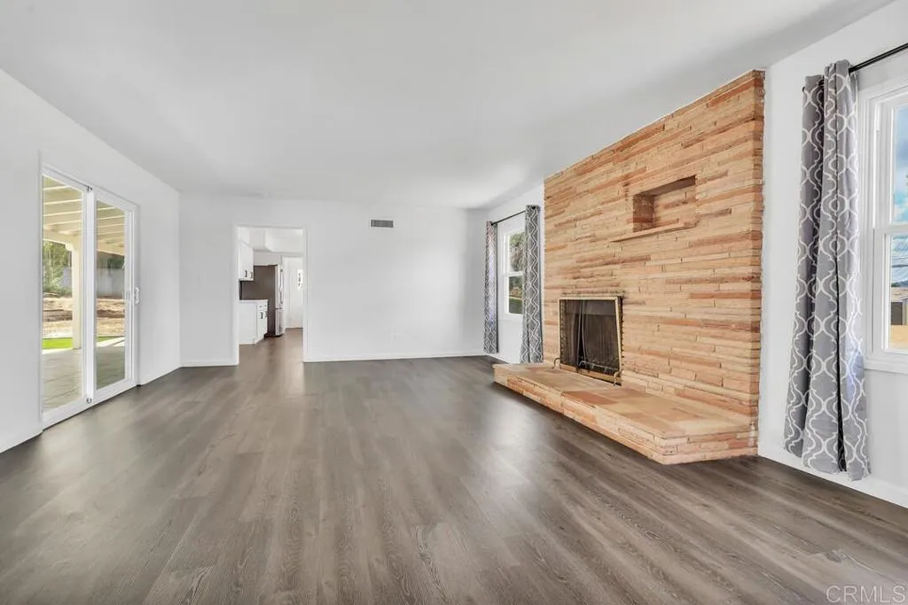 988 Pepper Drive El Cajon, CA 92021 - Photo 14 of 41 a view of empty room with a fireplace and wooden floor