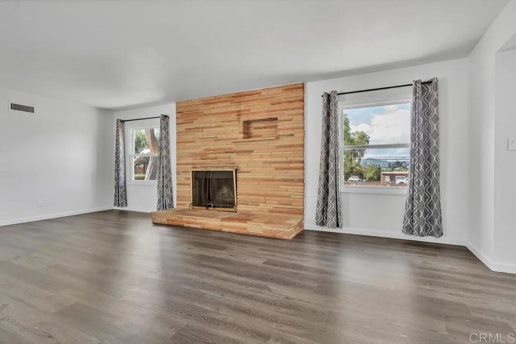 988 Pepper Drive El Cajon, CA 92021 - Photo 15 of 41 a view of an empty room with wooden floor and a window