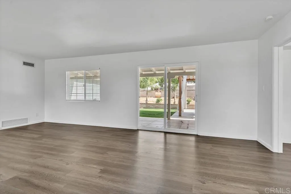 988 Pepper Drive El Cajon, CA 92021 - Photo 20 of 41 a view of an empty room with wooden floor and a window