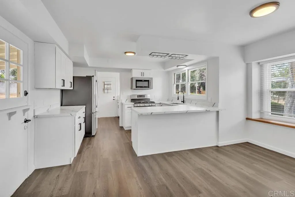 988 Pepper Drive El Cajon, CA 92021 - Photo 22 of 41 a kitchen with white cabinets and window