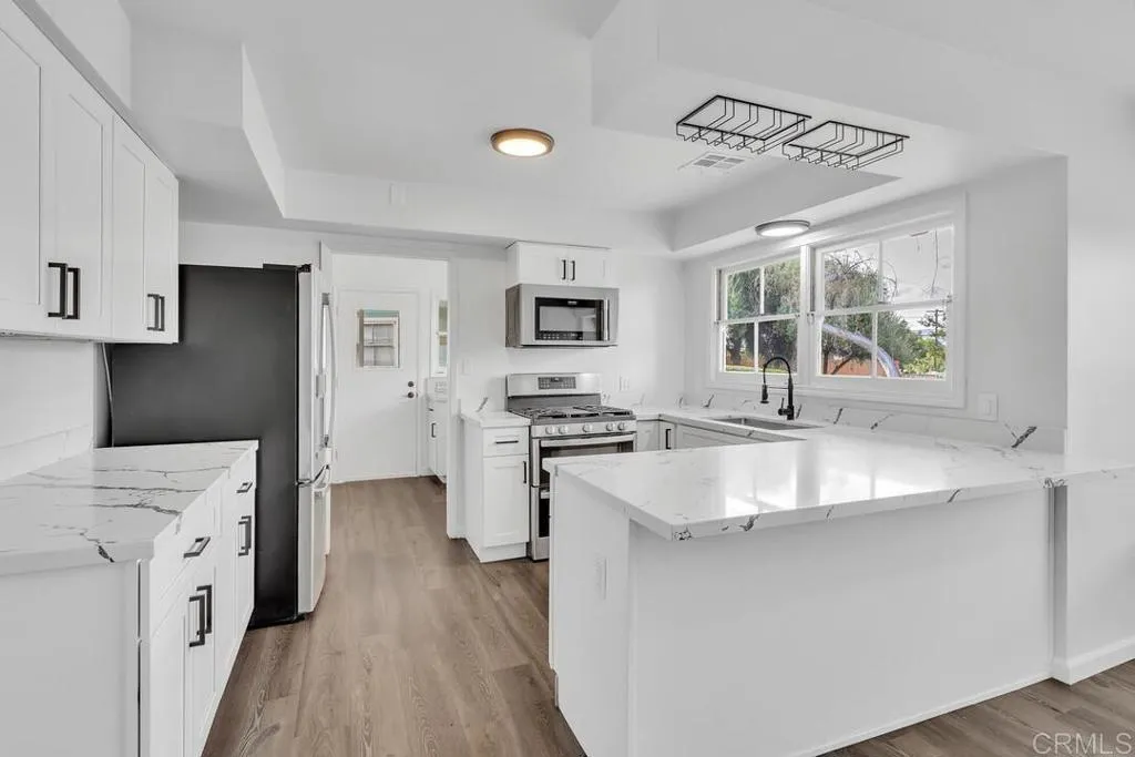 988 Pepper Drive El Cajon, CA 92021 - Photo 24 of 41 a kitchen with stainless steel appliances granite countertop a sink stove and refrigerator