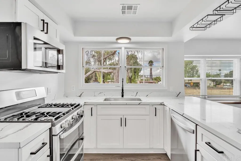 988 Pepper Drive El Cajon, CA 92021 - Photo 25 of 41 a kitchen that has a sink and a stove
