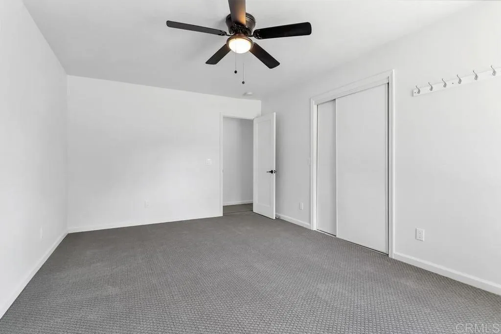 988 Pepper Drive El Cajon, CA 92021 - Photo 34 of 41 an empty room with a ceiling fan and carpet