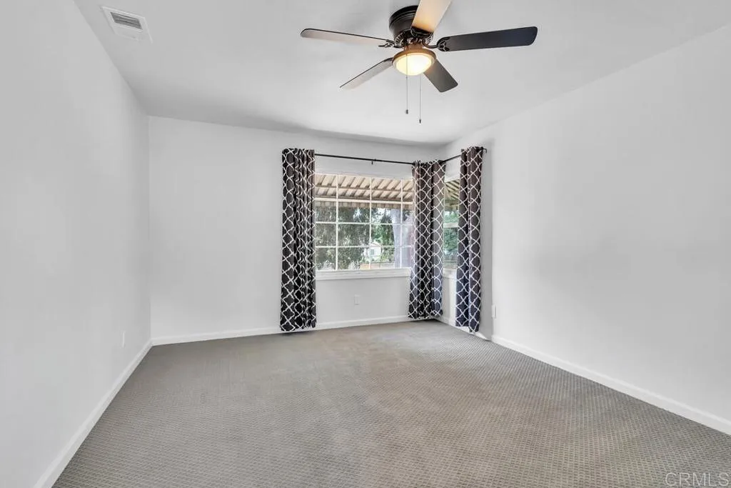 988 Pepper Drive El Cajon, CA 92021 - Photo 35 of 41 a view of a livingroom with a ceiling fan and window