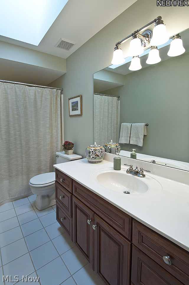 357 Longspur Road Highland Heights, OH 44143 - Photo 17 of 22 Large light-filled second floor bathroom features new skylight and large cherry wood vanity with drawers and new brushed nickel faucet and light fixture