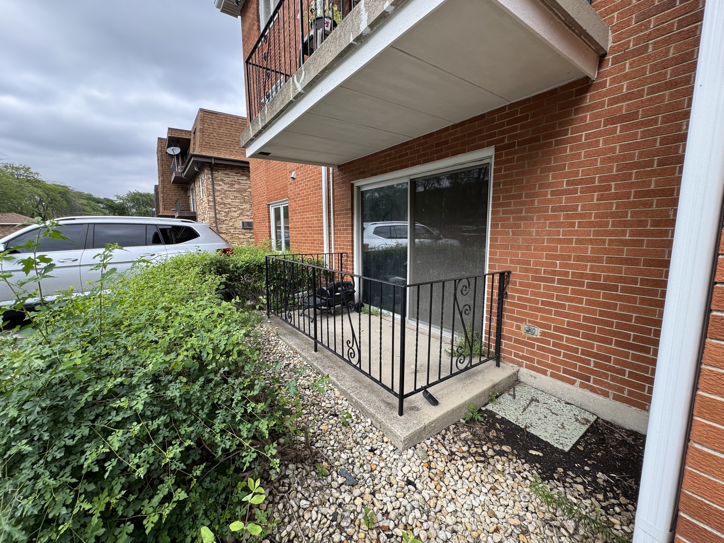 10840 Kilpatrick Avenue, Unit 1NW Oak Lawn, IL 60453 - Photo 10 of 11 a view of a brick house with a small yard and wooden floor and fence