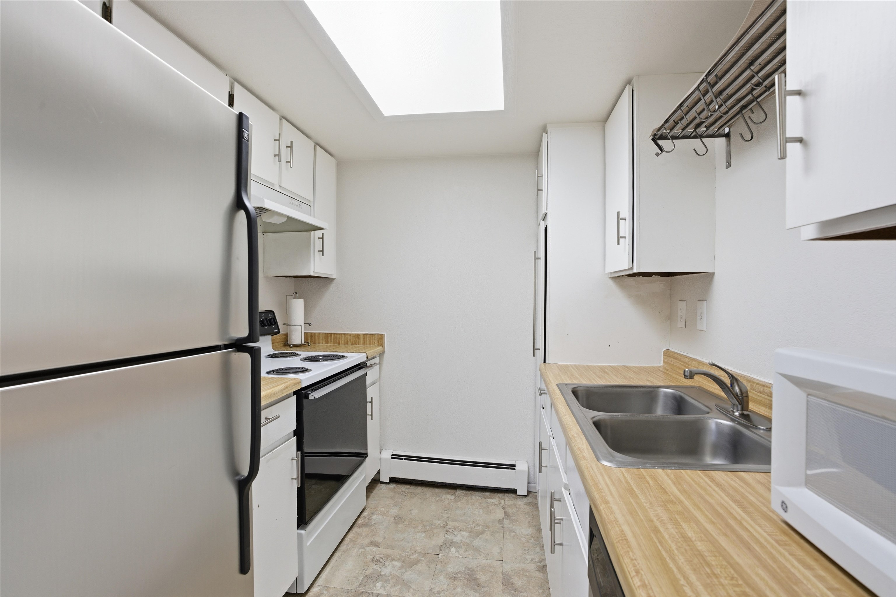 1140 Walnut Avenue, Unit 17 Grand Junction, CO 81501 - Photo 5 of 15 a kitchen with stainless steel appliances granite countertop a refrigerator and a sink