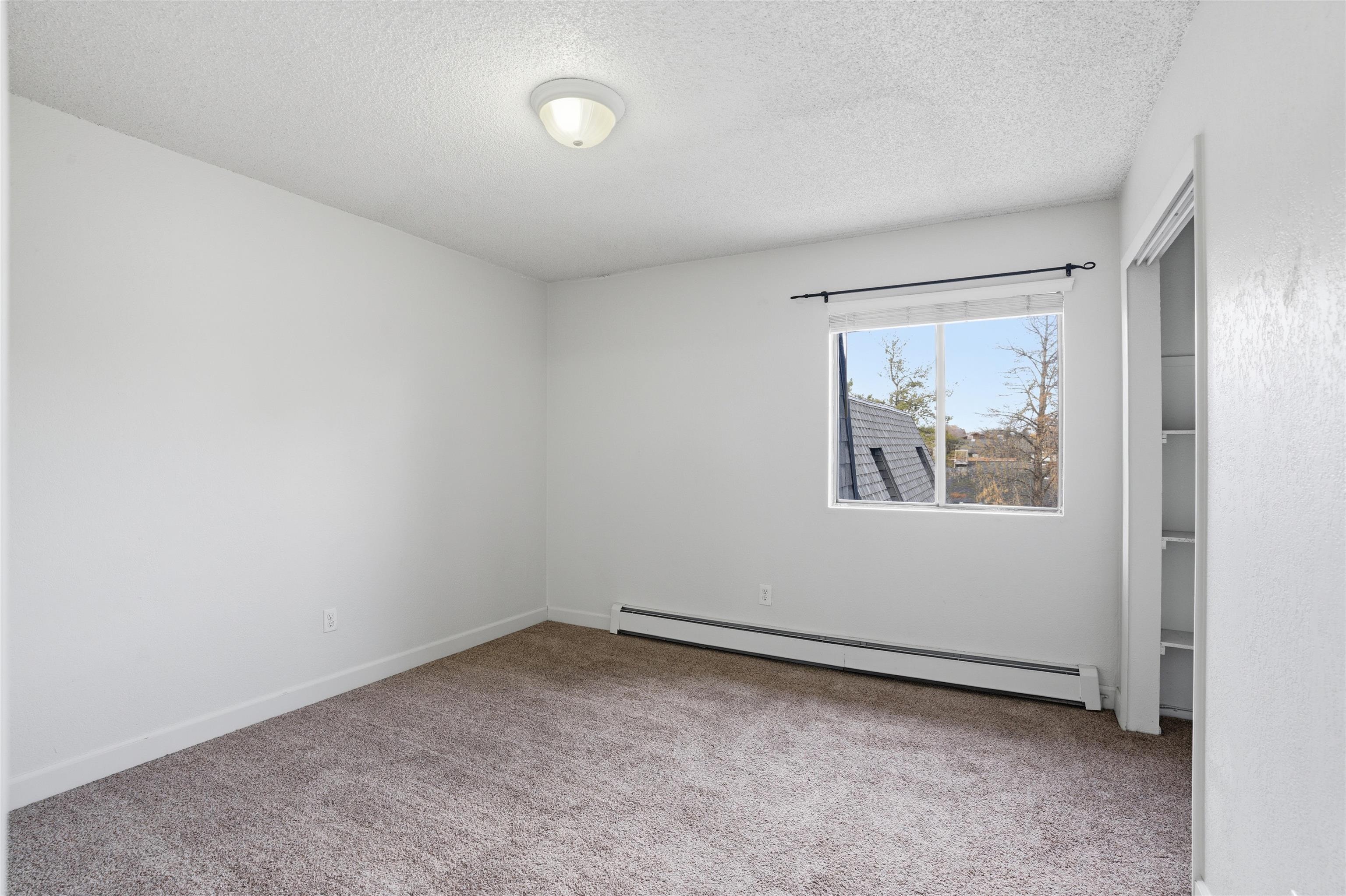 1140 Walnut Avenue, Unit 17 Grand Junction, CO 81501 - Photo 10 of 15 an empty room with a window