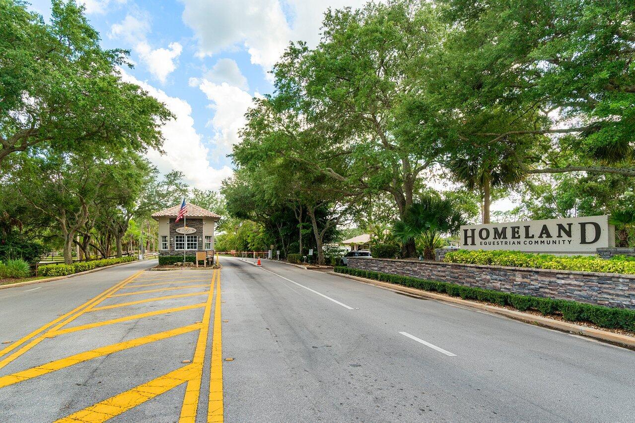 6248 Homeland Road Lake Worth, FL 33449 - Photo 11 of 22 a view of a street with a building and trees in the background