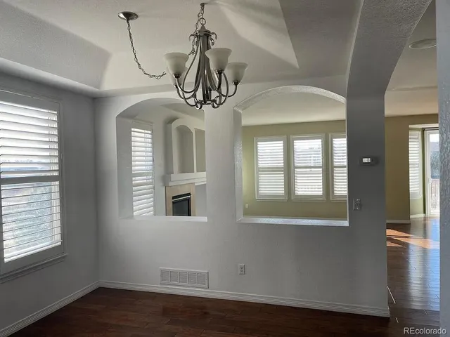 a view of a livingroom with wooden floor and windows