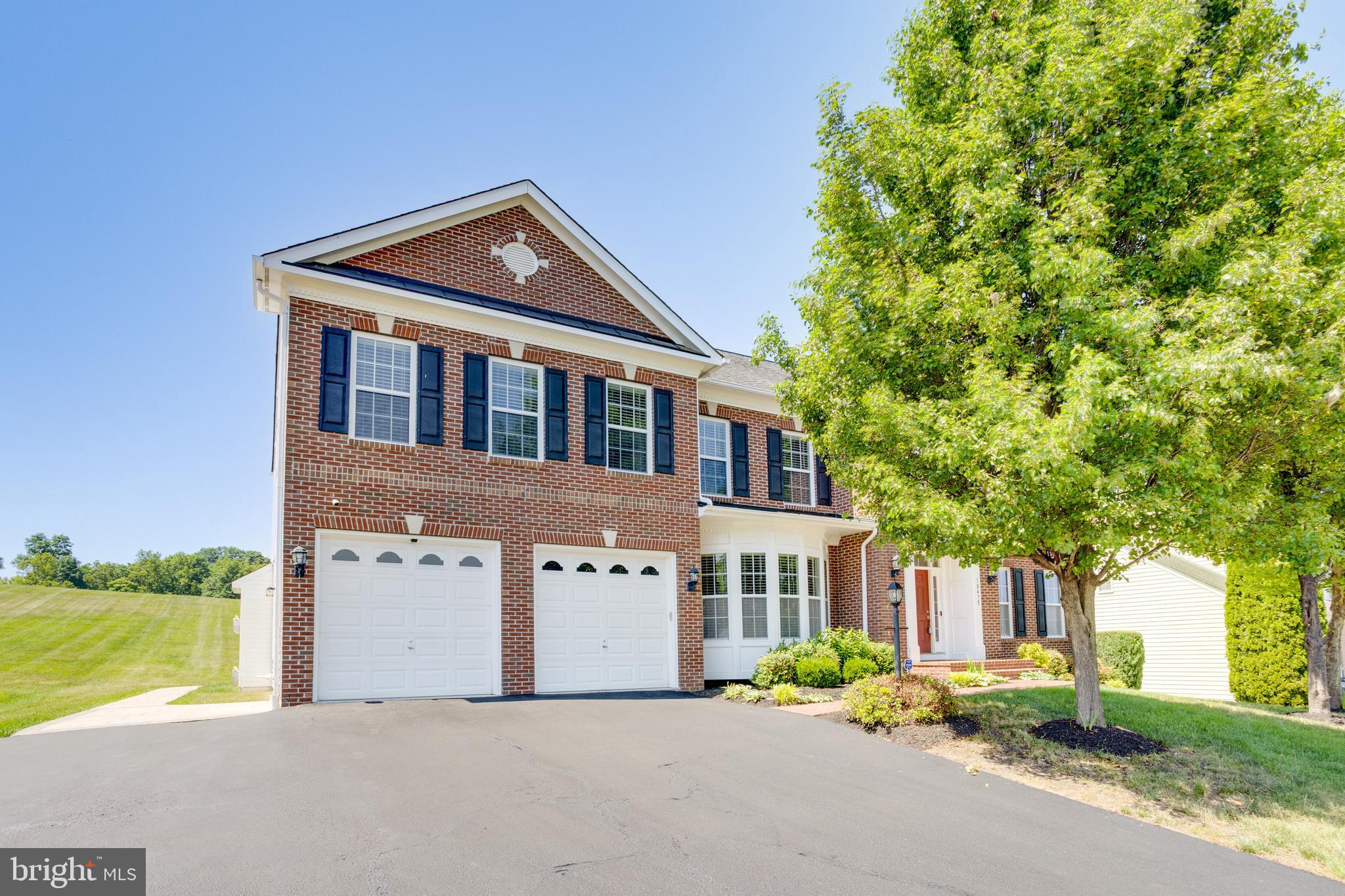 18475 Kerill Road Triangle, VA 22172 - Photo 22 of 99 a front view of a house with a yard and garage