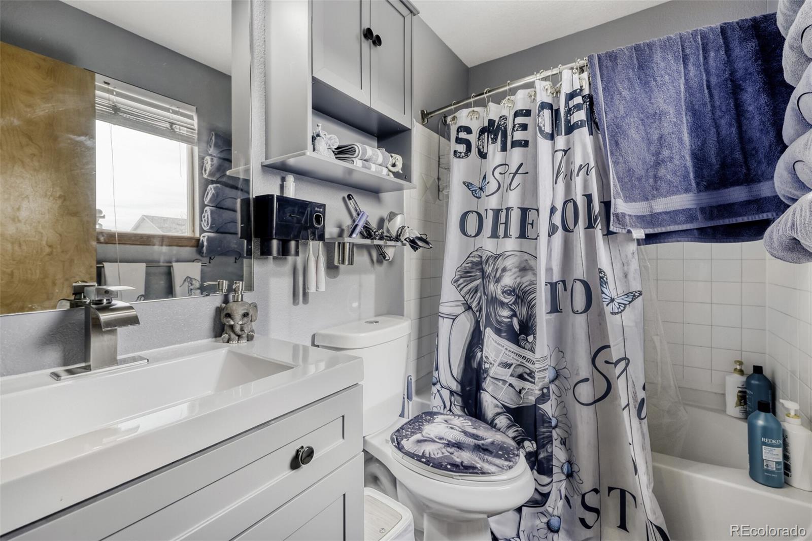 1435 Hummingbird Circle Brighton, CO 80601 - Photo 17 of 22 a bathroom with a sink toilet and shower