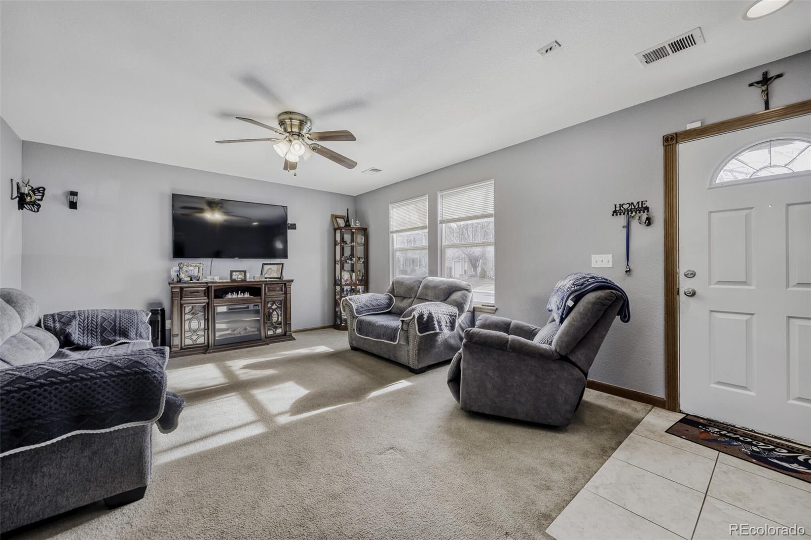 1435 Hummingbird Circle Brighton, CO 80601 - Photo 19 of 22 a living room with furniture and a flat screen tv