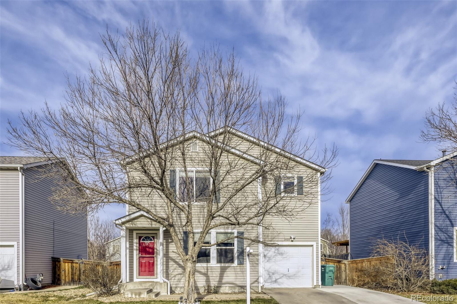 1435 Hummingbird Circle Brighton, CO 80601 - Photo 3 of 22 a front view of a house with a yard