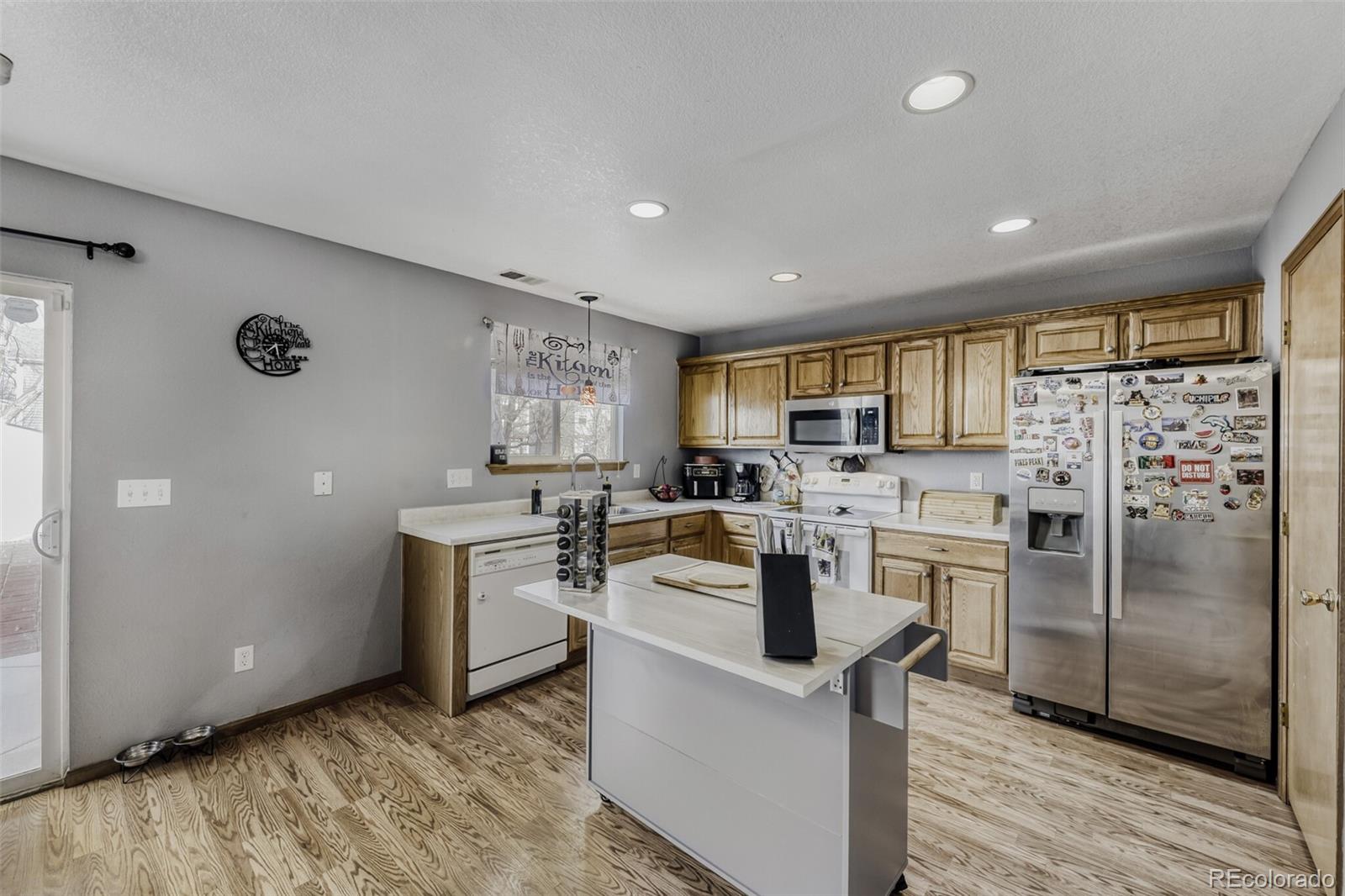 1435 Hummingbird Circle Brighton, CO 80601 - Photo 8 of 22 a kitchen with a refrigerator a sink dishwasher stove and oven