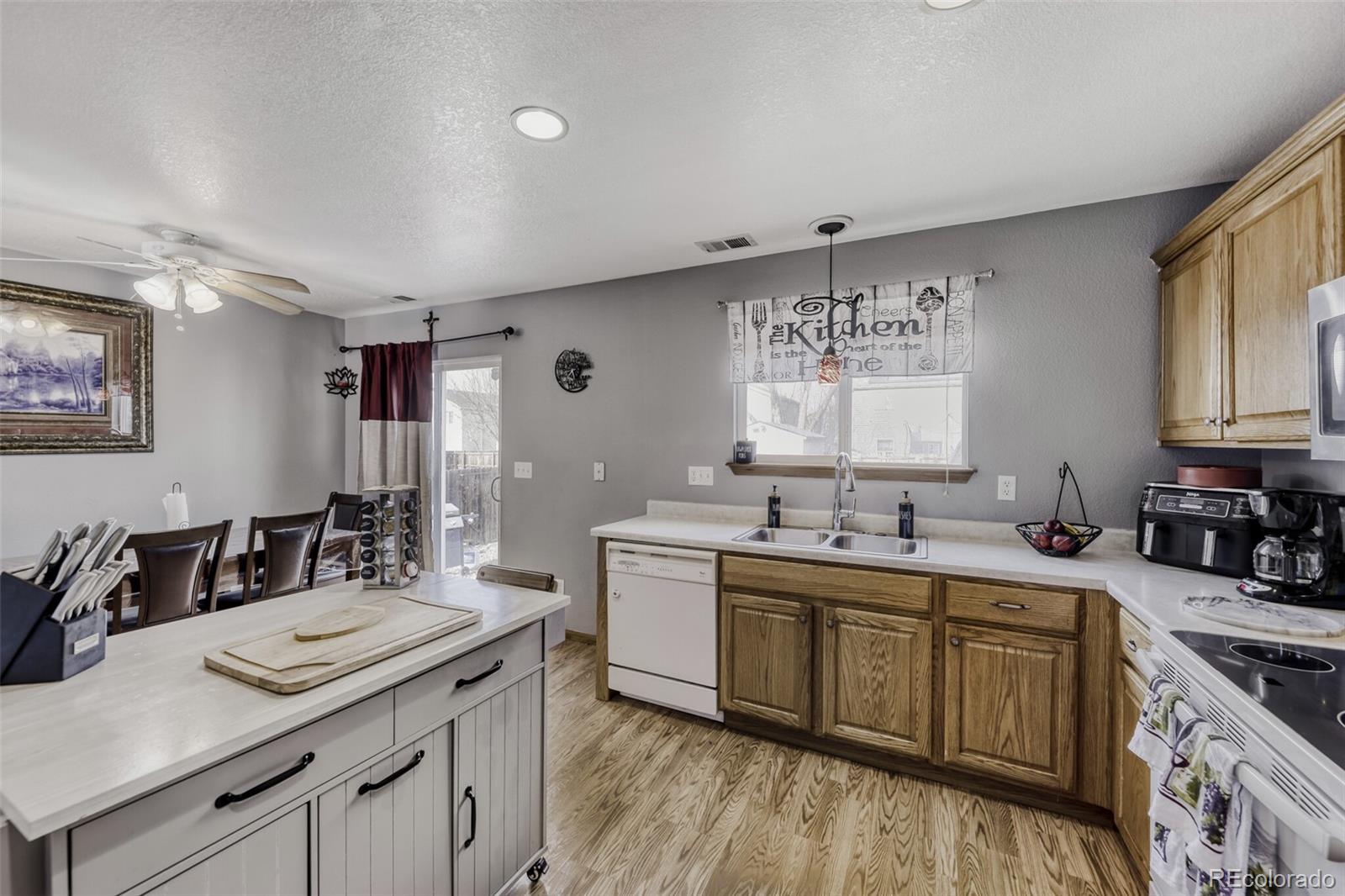 1435 Hummingbird Circle Brighton, CO 80601 - Photo 9 of 22 a kitchen with a sink stove and cabinets