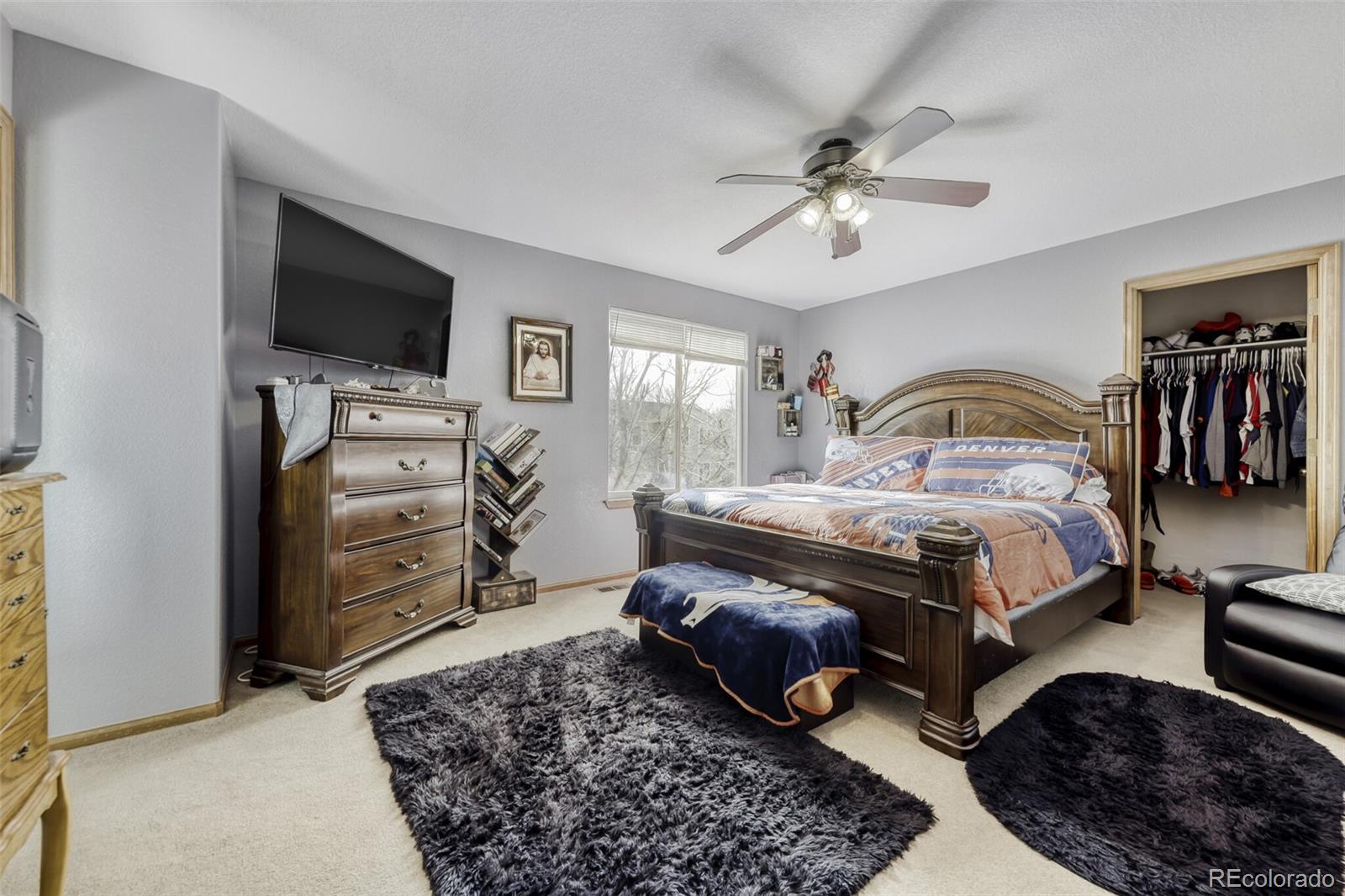 1435 Hummingbird Circle Brighton, CO 80601 - Photo 10 of 22 a bedroom with a bed and a flat screen tv