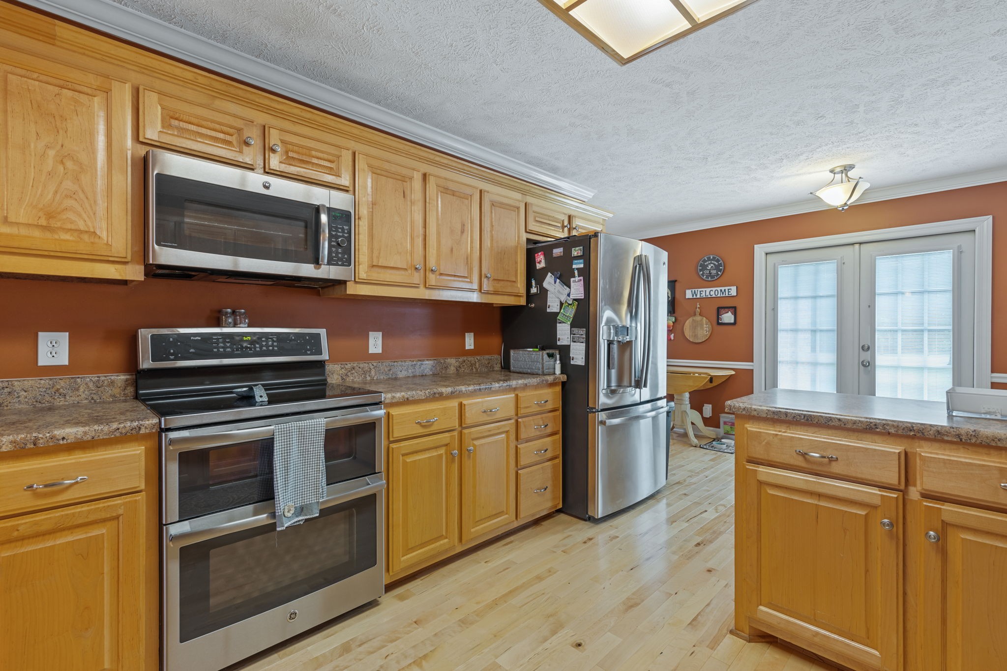 1972 Espy Road Bradyville, TN 37026 - Photo 16 of 67 a kitchen with stainless steel appliances granite countertop a stove microwave and refrigerator