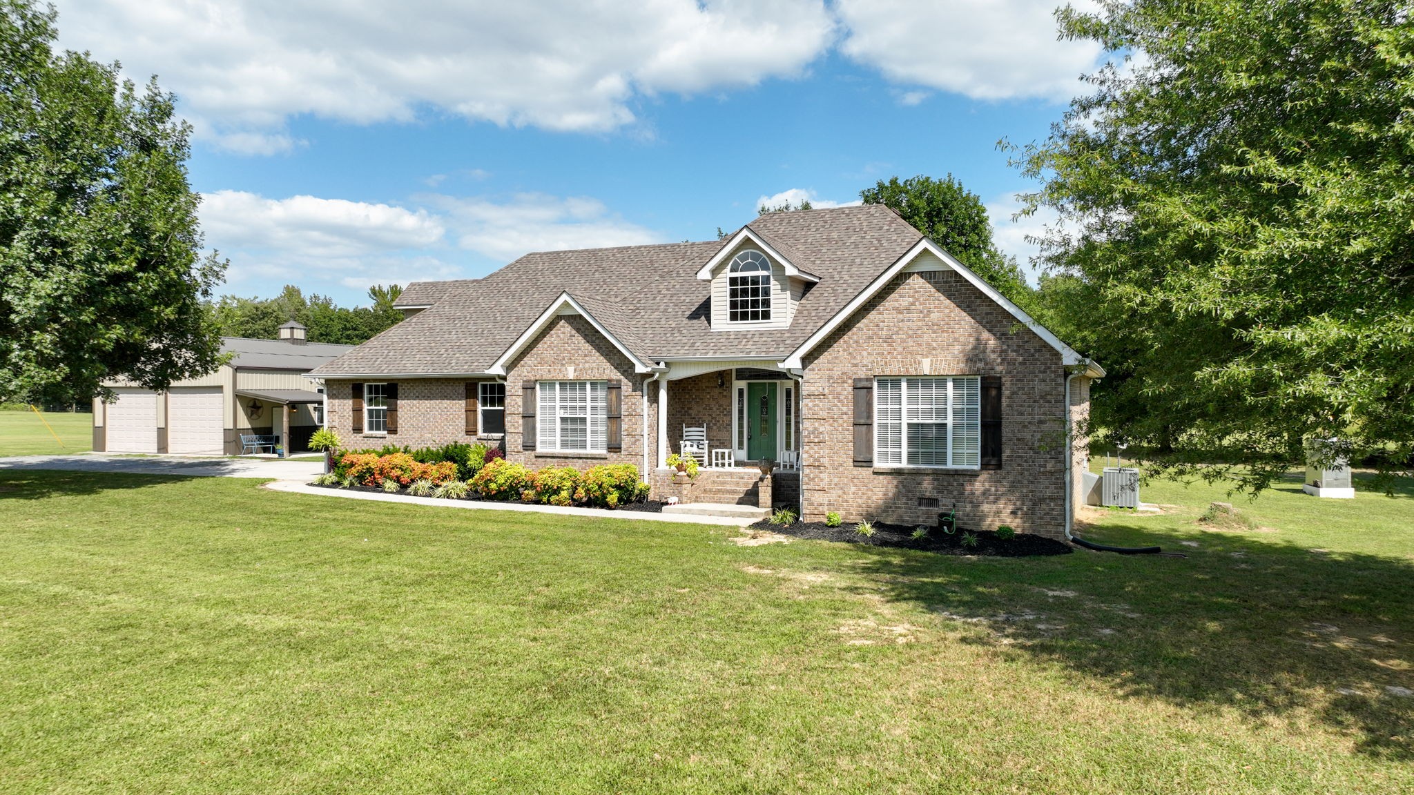 1972 Espy Road Bradyville, TN 37026 - Photo 3 of 67 a front view of a house with a yard and garage