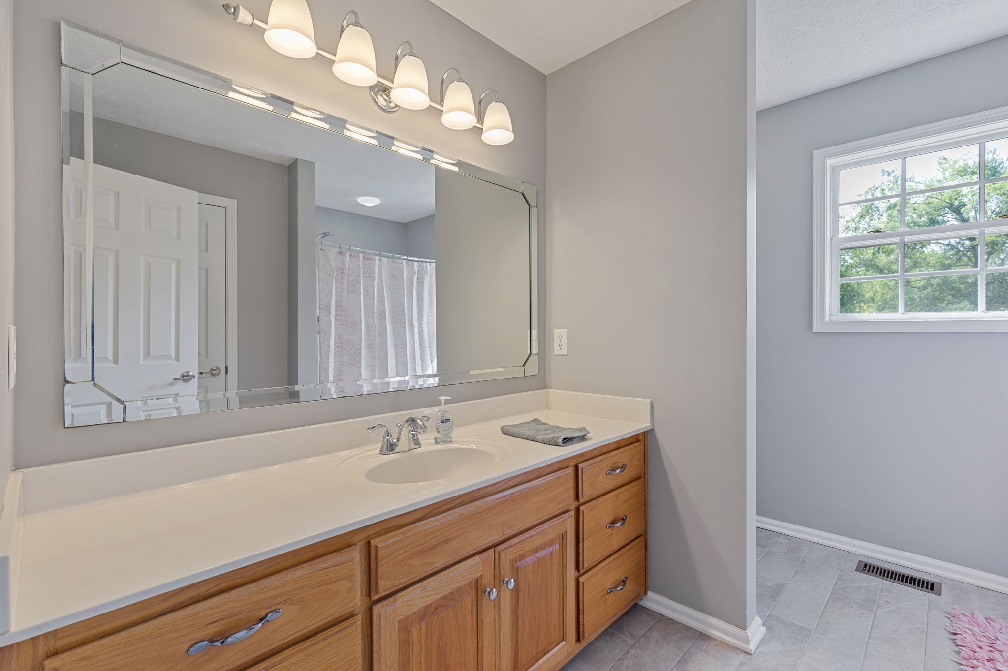 1972 Espy Road Bradyville, TN 37026 - Photo 35 of 67 a bathroom with a sink a large mirror and a window