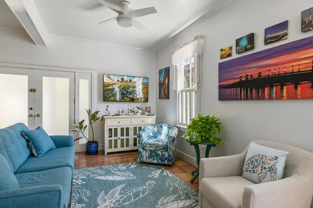 a living room with furniture flowerpot and window