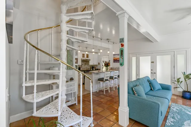 a living room with furniture a rug and a chandelier
