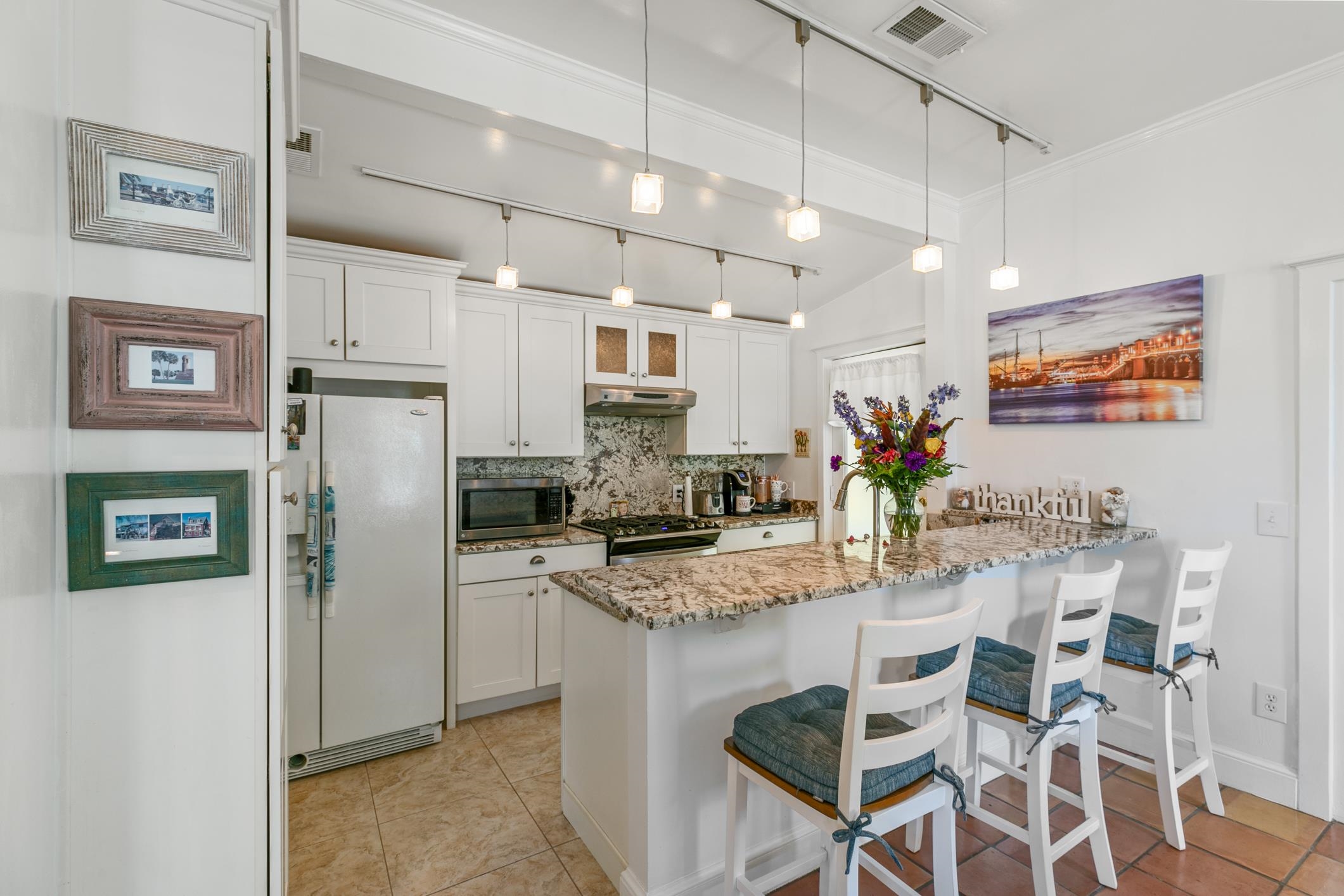 46 St Francis Street St. Augustine, FL 32084 - Photo 17 of 48 a kitchen with stainless steel appliances granite countertop a refrigerator and a stove top oven