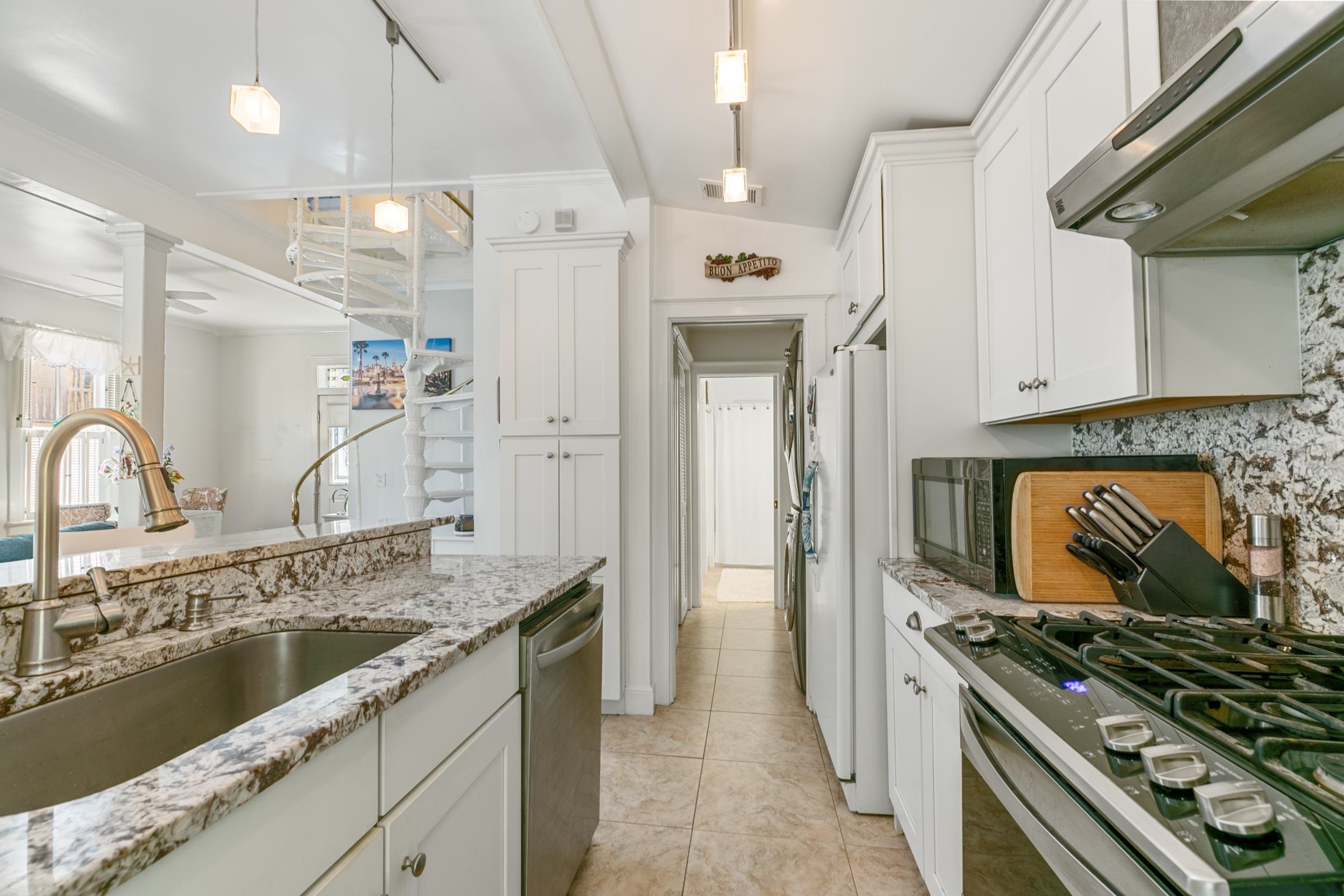 46 St Francis Street St. Augustine, FL 32084 - Photo 20 of 48 a kitchen with granite countertop a stove and a sink