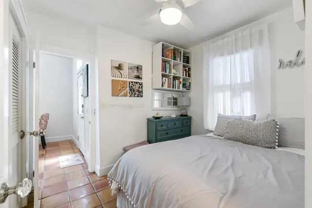 a bedroom with a large bed and a window
