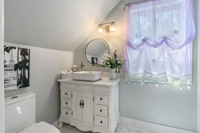 a bathroom with a sink mirror and vanity
