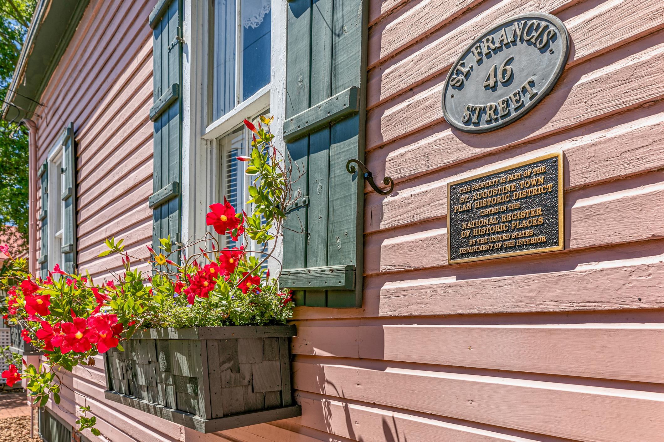 46 St Francis Street St. Augustine, FL 32084 - Photo 40 of 48 a potted plant sitting on the side of a brick building