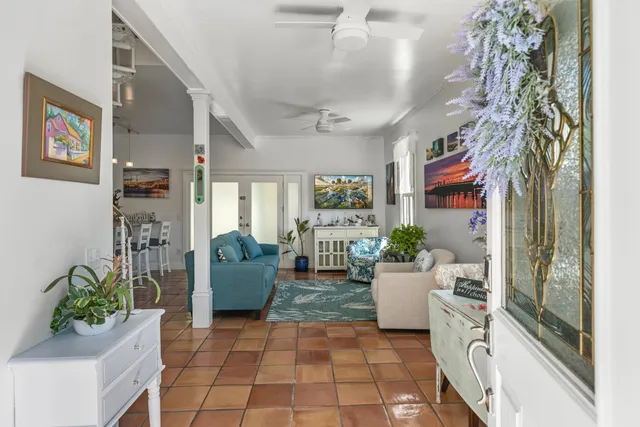 a living room with furniture and a potted plant