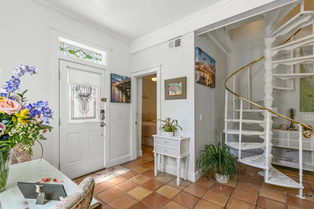 a living room with furniture and flowers