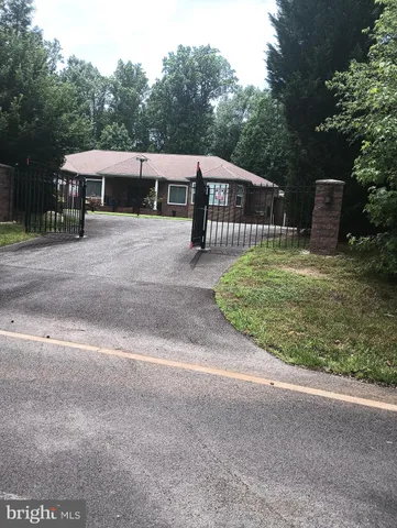 a front view of a house with a yard and a garage