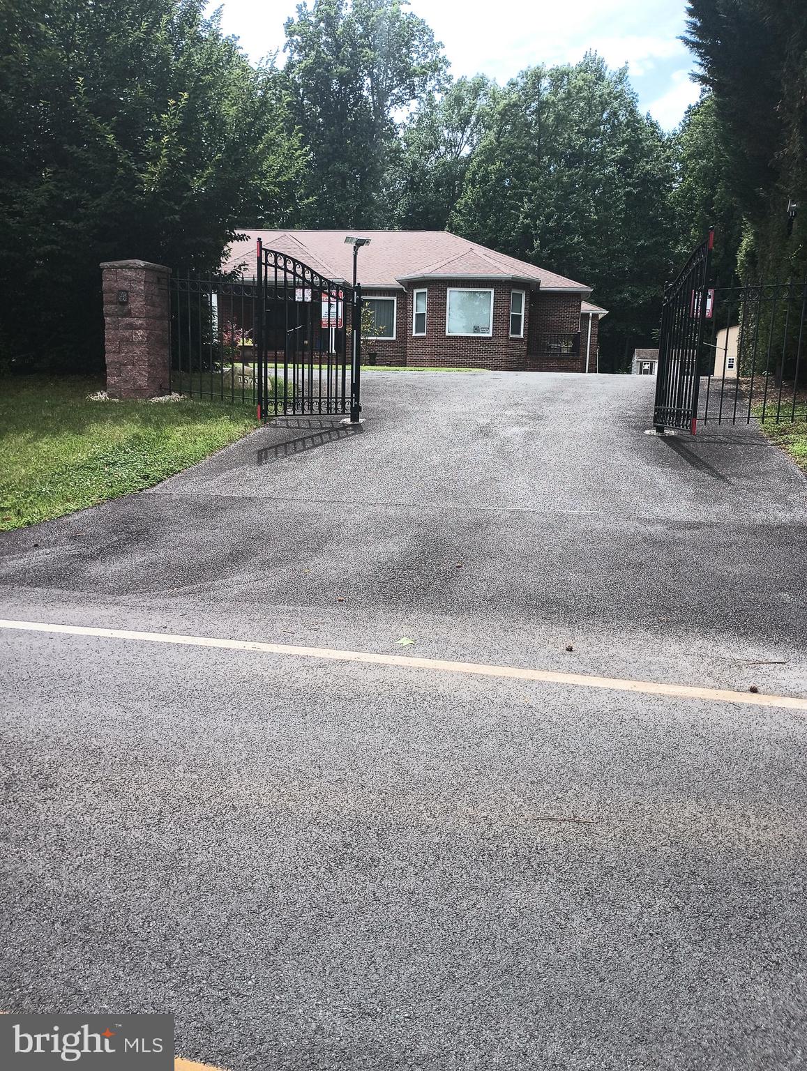 16501 Nottingham Road Upper Marlboro, MD 20772 - Photo 6 of 9 a view of a house with a yard and large trees