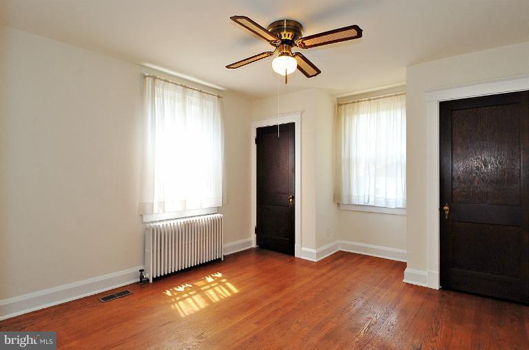 205 Hawthorne Road Linthicum Heights, MD 21090 - Photo 16 of 24 a view of an empty room with a window and wooden floor