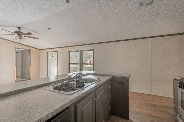 a kitchen with a sink stove and cabinets