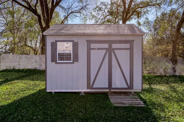 a view of a backyard with a small cabin