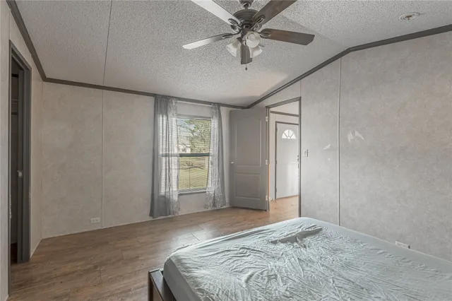 a view of a livingroom with a ceiling fan and window