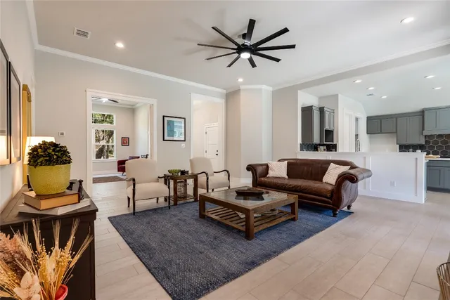 a living room with furniture and kitchen view
