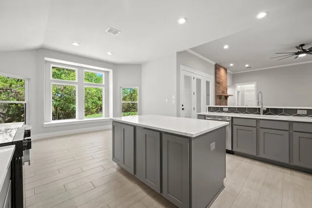 a kitchen with a sink stove and cabinets