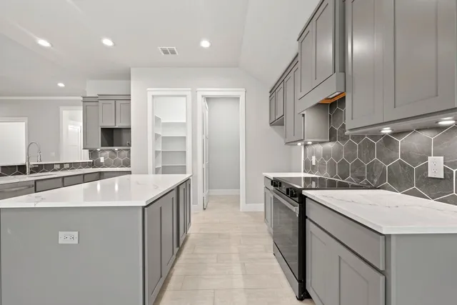 a kitchen with stainless steel appliances granite countertop a sink and a stove