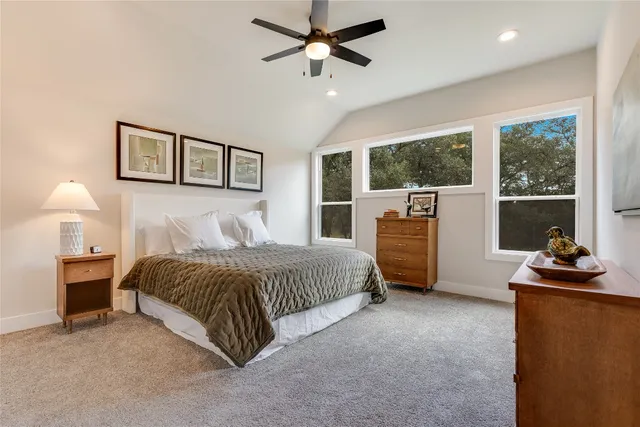 a bedroom with a bed dresser and a window